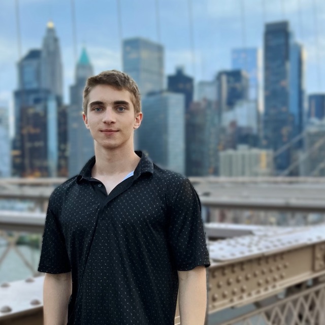 Tymur on the Brooklyn Bridge, Manhattan skyline behind