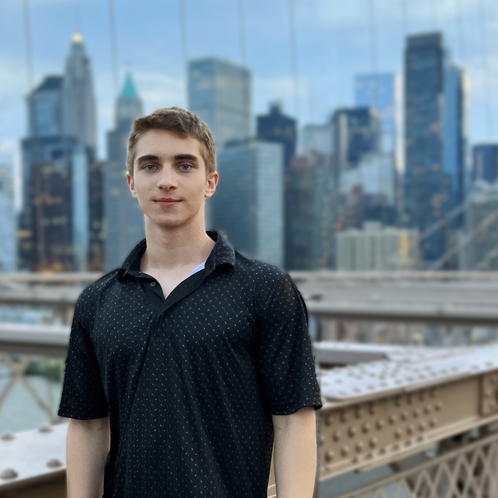 Tymur on the Brooklyn Bridge, Manhattan skyline behind